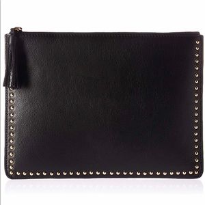 Black leather clutch with tassel and gold studs.